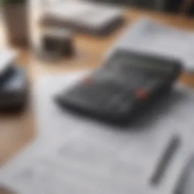 A close-up view of a financial calculator and loan documents on a desk