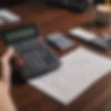 A person analyzing their monthly budget with a calculator and notepad.